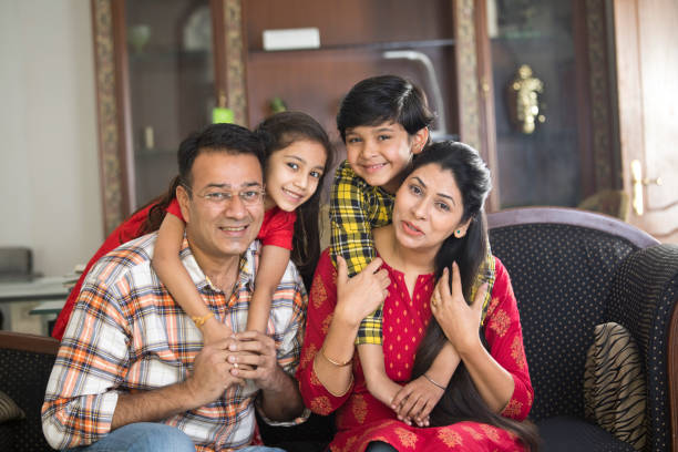 Happy Indian family sitting on sofa in the living room